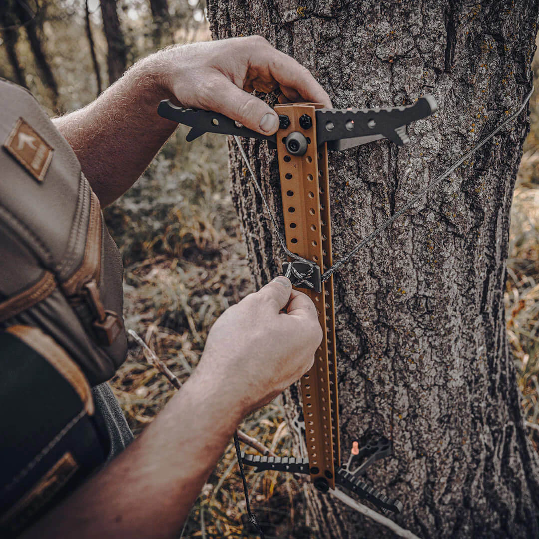 SKELETORS CLIMBING STICKS 4PK being installed on a tree.