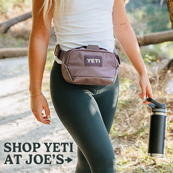 Shop all Yeti products at Joes.  Picture shows a woman wearing a yeti waist pack and holding a yeti water bottle.