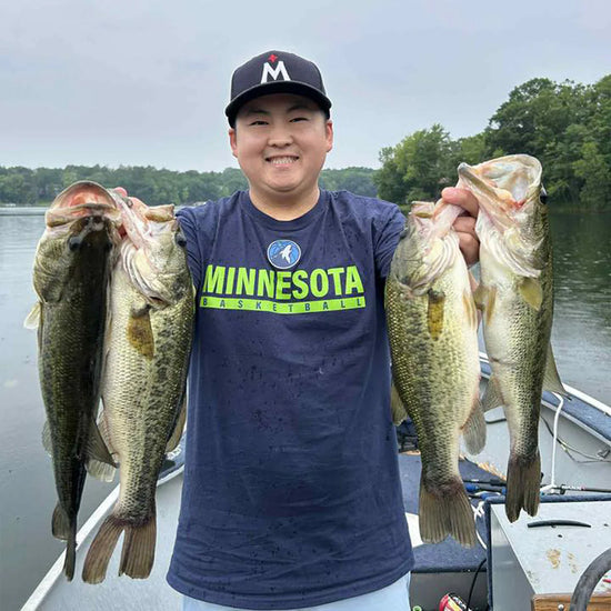 Austin F. displaying his catch of large mouth bass.