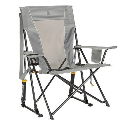 GCI Outdoor Comfort Pro Rocker folding camp chair in mercury gray, featuring a mesh back panel, padded armrests, a drink holder, and shock-absorbing rocker legs designed for outdoor use.