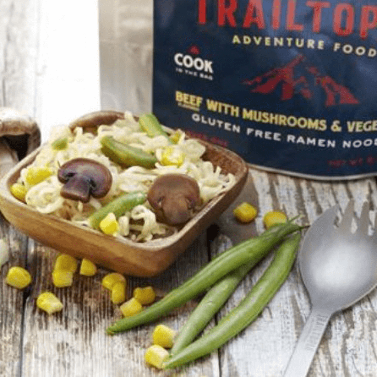 Trailtop Adventure Food beef with mushrooms and vegetables ramen noodles on a wooden surface.