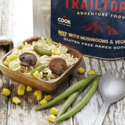 Trailtop Adventure Food beef with mushrooms and vegetables ramen noodles on a wooden surface.