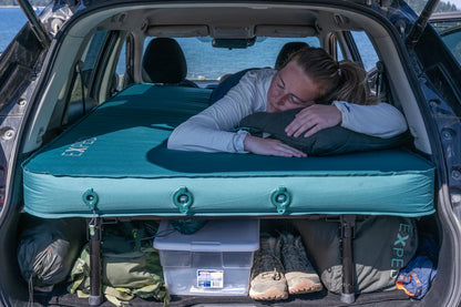 EXPED MEGAMAT DUO SLEEPING PAD - MEDIUM - CYPRESS being used in the back of a car