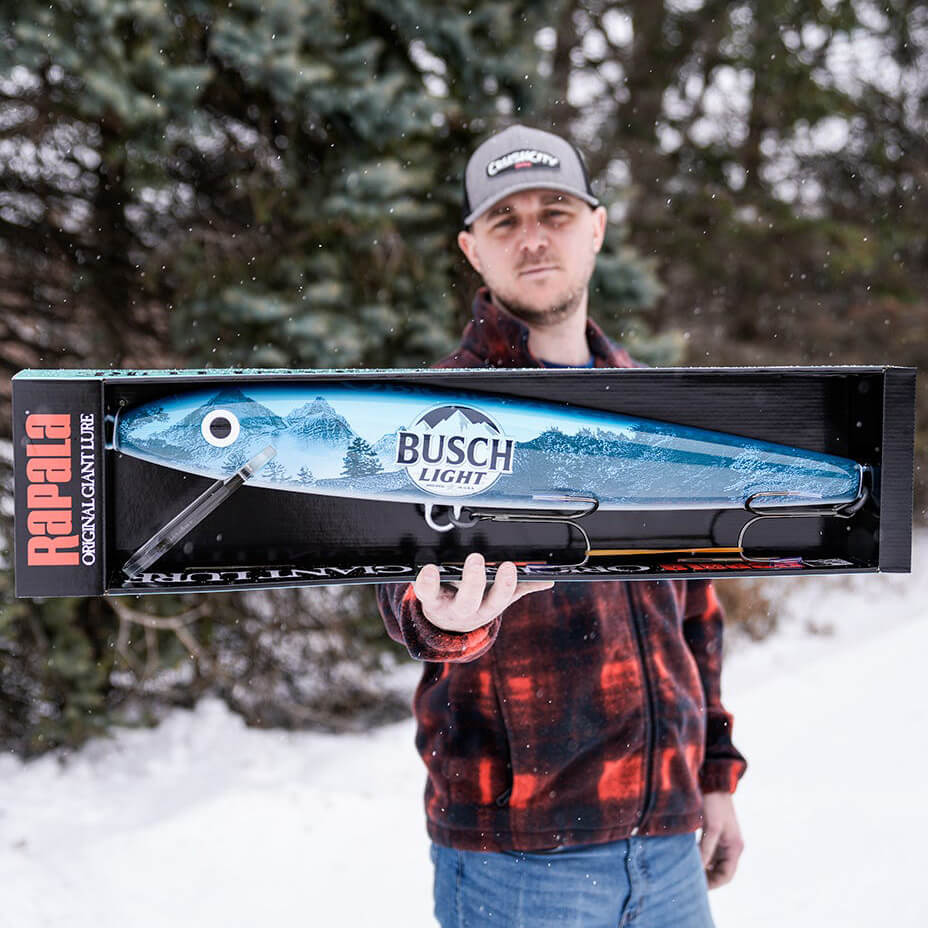 RAPALA GIANT LURE BUSCH LIGHT - 29 INCHES with a man holding it for scale