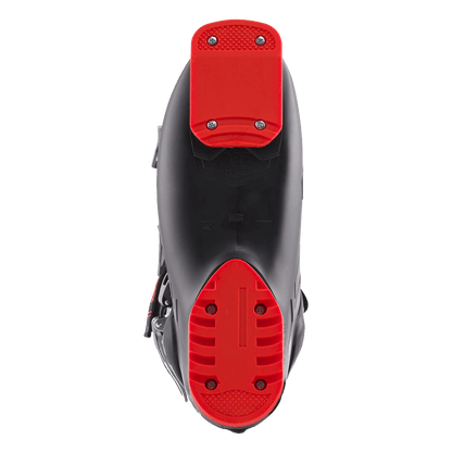 Close-up of a scooter with red foot pegs on a black background