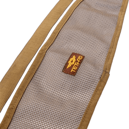 Close-up of tethrd modular versatile panel (MVP) in tan mesh design with adjustable strap and buckle, designed for added back support in saddle hunting setups.
