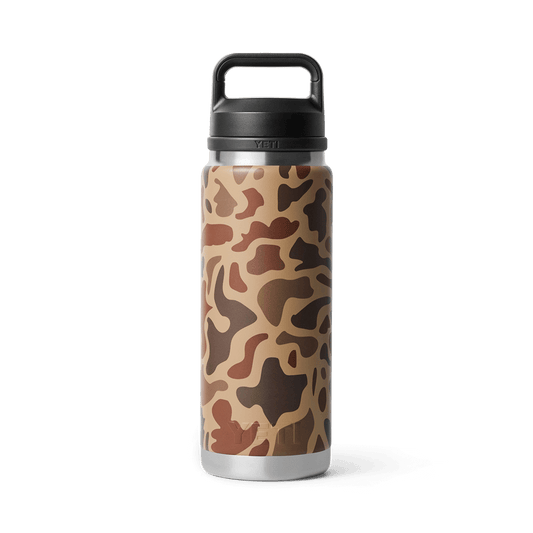 YETI Rambler 26 oz Bottle with Chug Cap in Wetlands Camo color pattern, featuring an abstract brown and tan camouflage design with a durable black lid and wide handle.